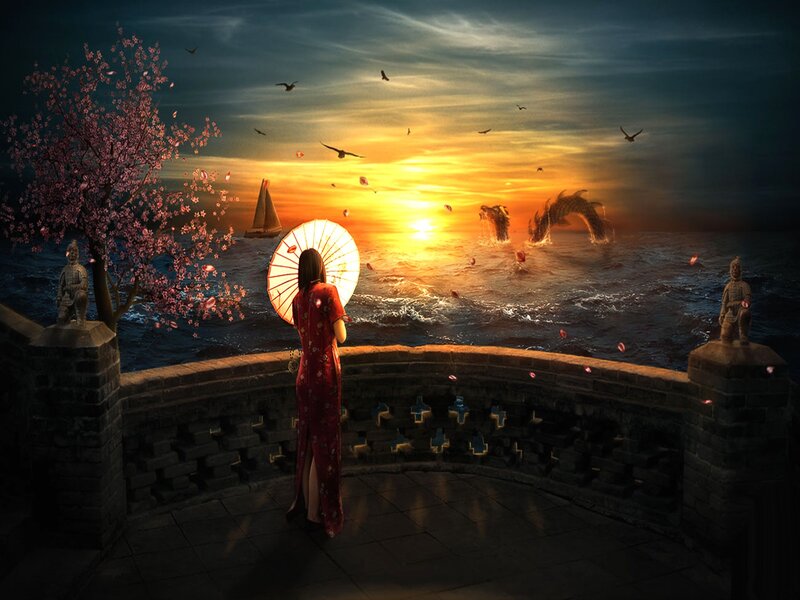 Woman with parasol at sunset