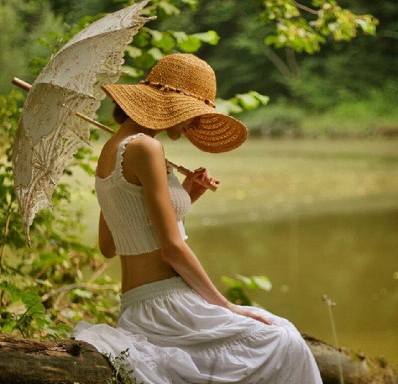 Woman with parasol by the lake