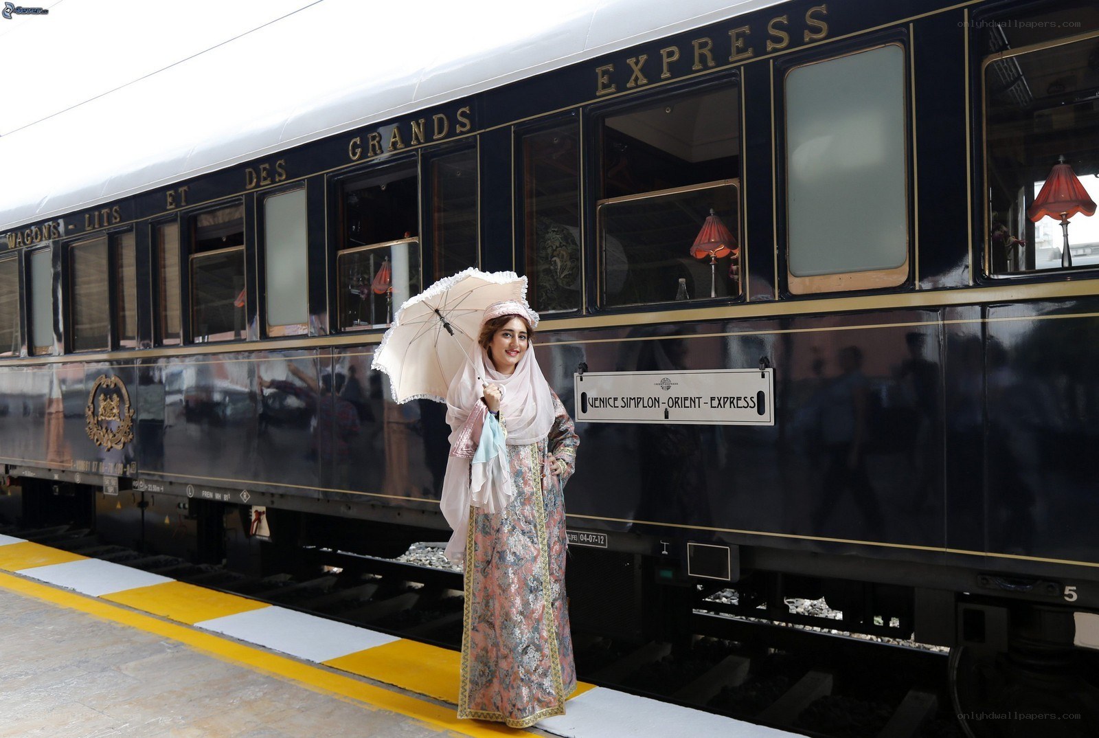 Woman with parasol by train