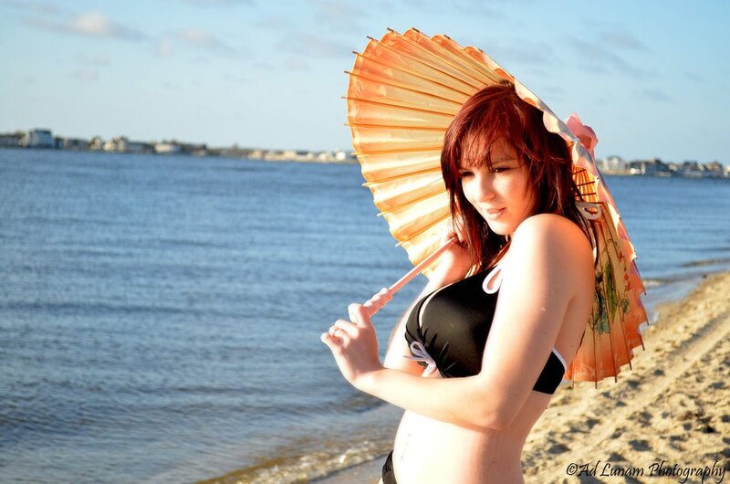 Woman with parasol on beach