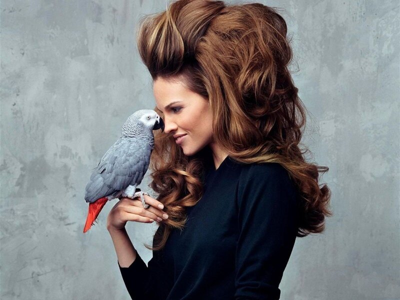 woman with parrot on hand