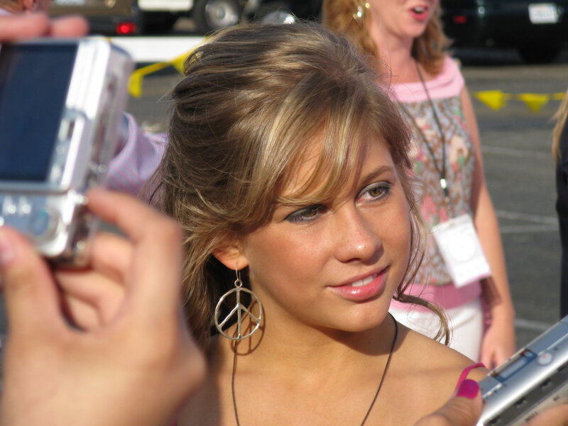 woman with peace sign earrings