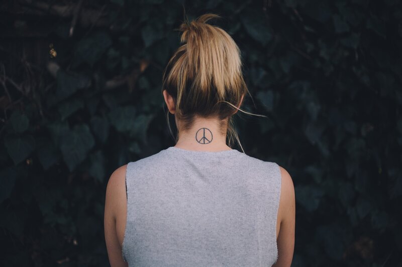 woman with peace sign tattoo