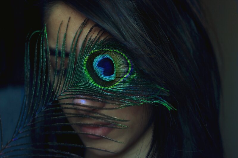 woman with peacock feather