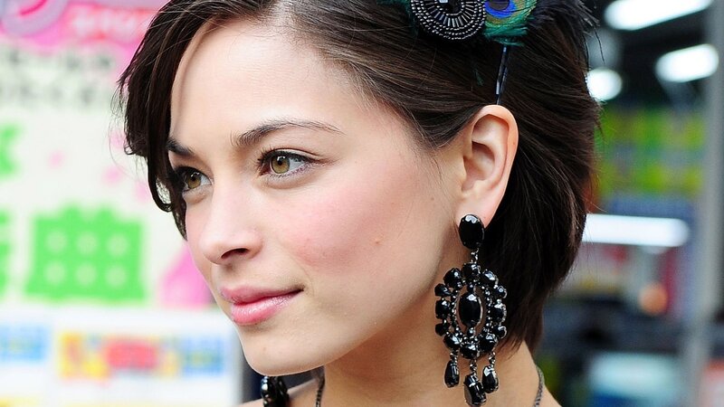woman with peacock feather hair accessory