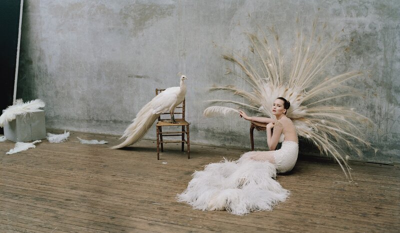 woman with peacock feathers