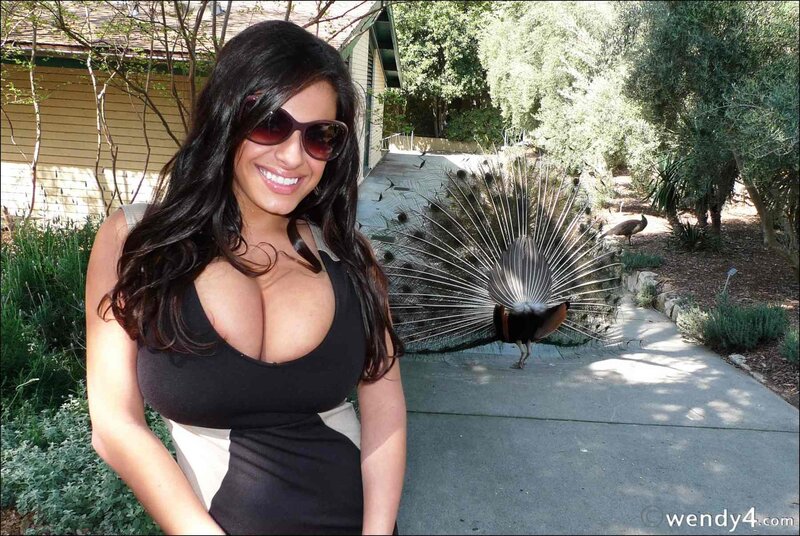 Woman with peacock in garden
