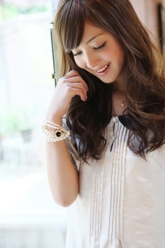 woman with pearl bracelet smiling