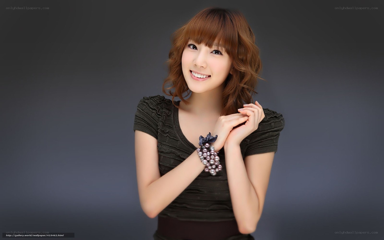 woman with pearl bracelet smiling