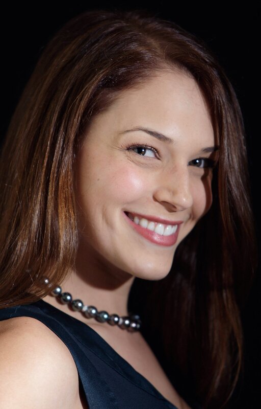 woman with pearl necklace smiling