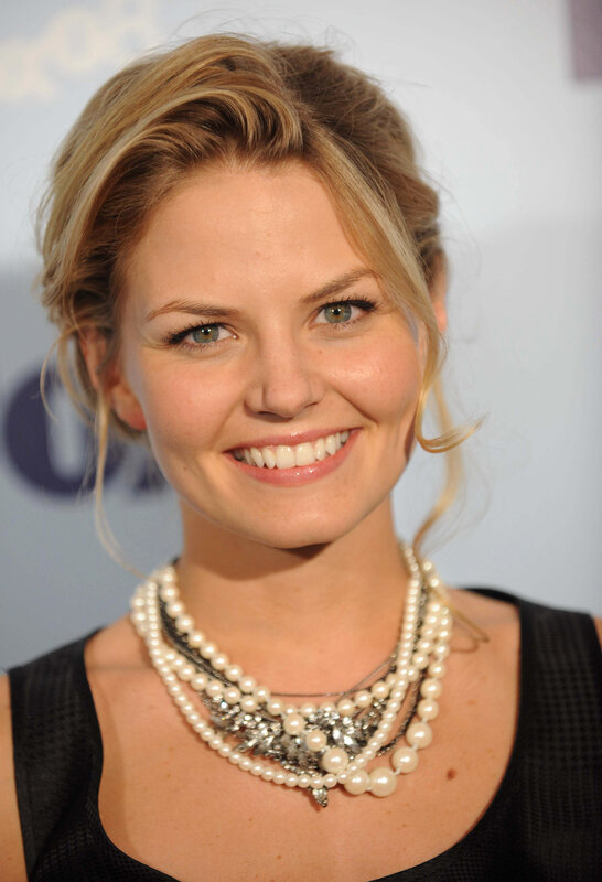 woman with pearl necklace smiling