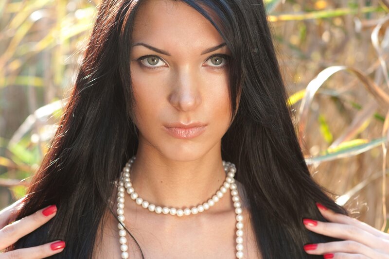 woman with pearls in nature