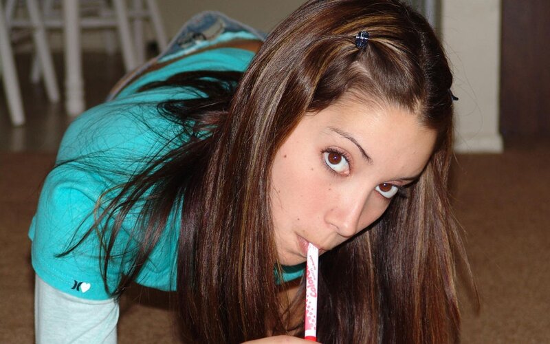 woman with pen in mouth