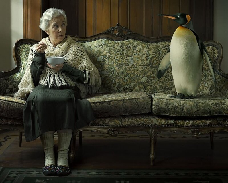 Woman with penguin on couch