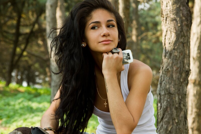 woman with phone in forest