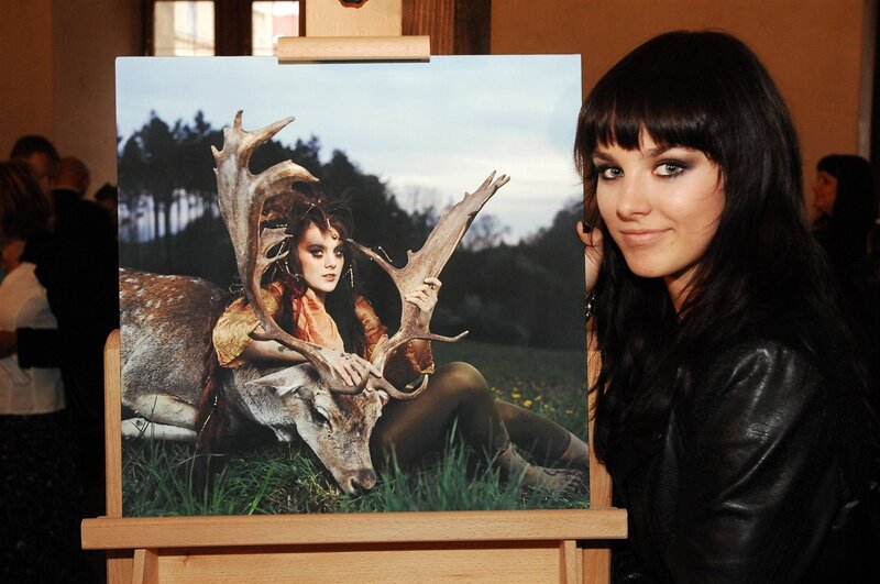 Woman with photo of woman and deer