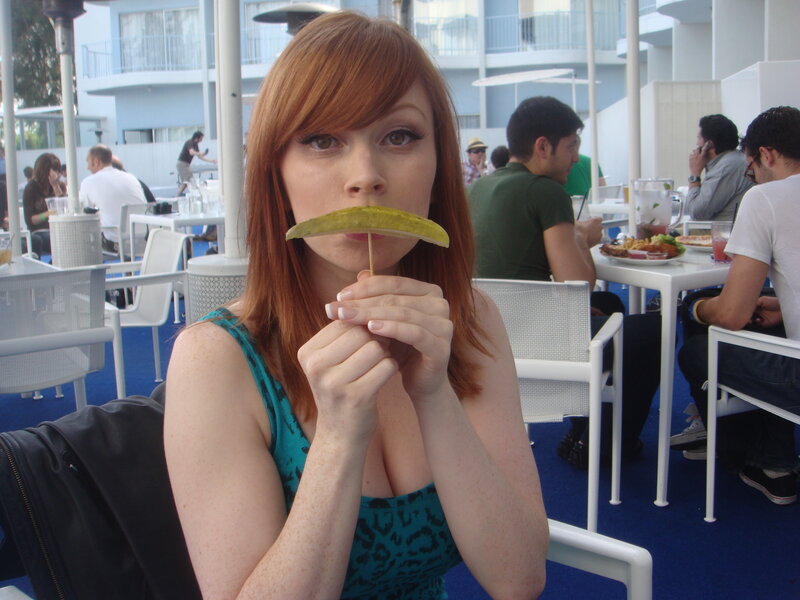 Woman with pickle on stick