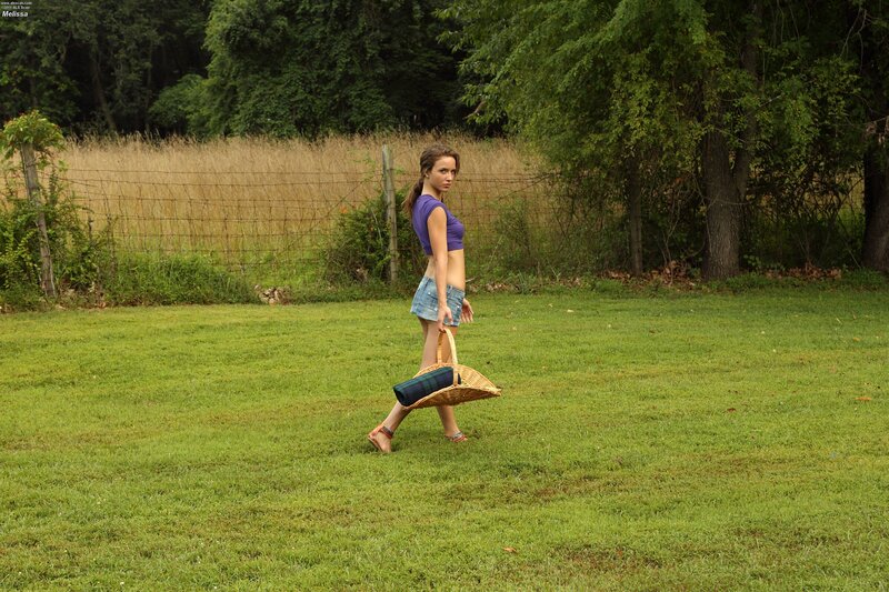 Woman with picnic basket in field