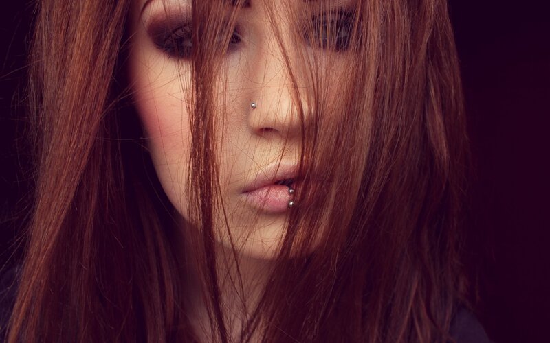 woman with piercings and dark makeup