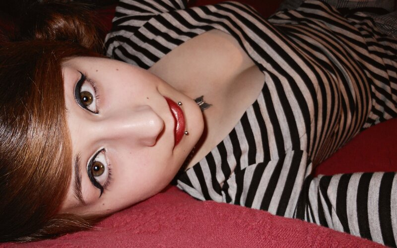 woman with piercings and makeup