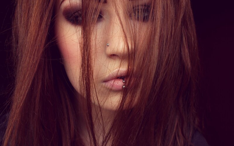 woman with piercings and red hair