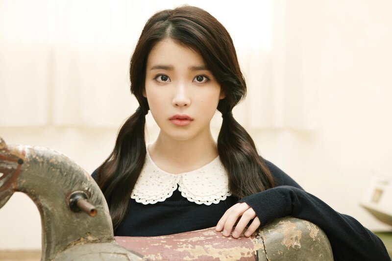 woman with pigtails and vintage toy