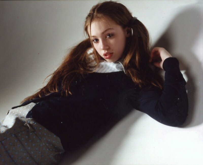 woman with pigtails lying down