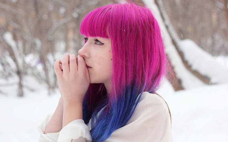 woman with pink and blue hair in snow