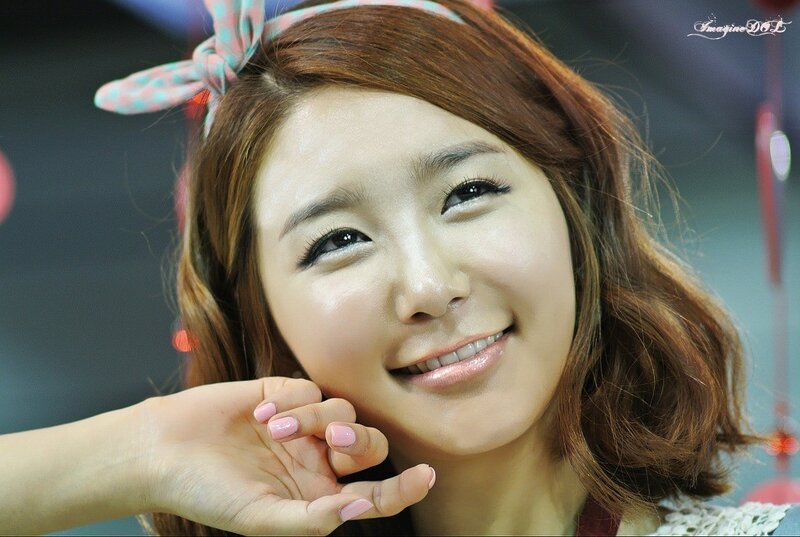 woman with pink bow smiling