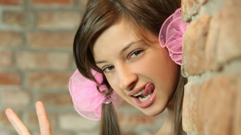 woman with pink bows making a face