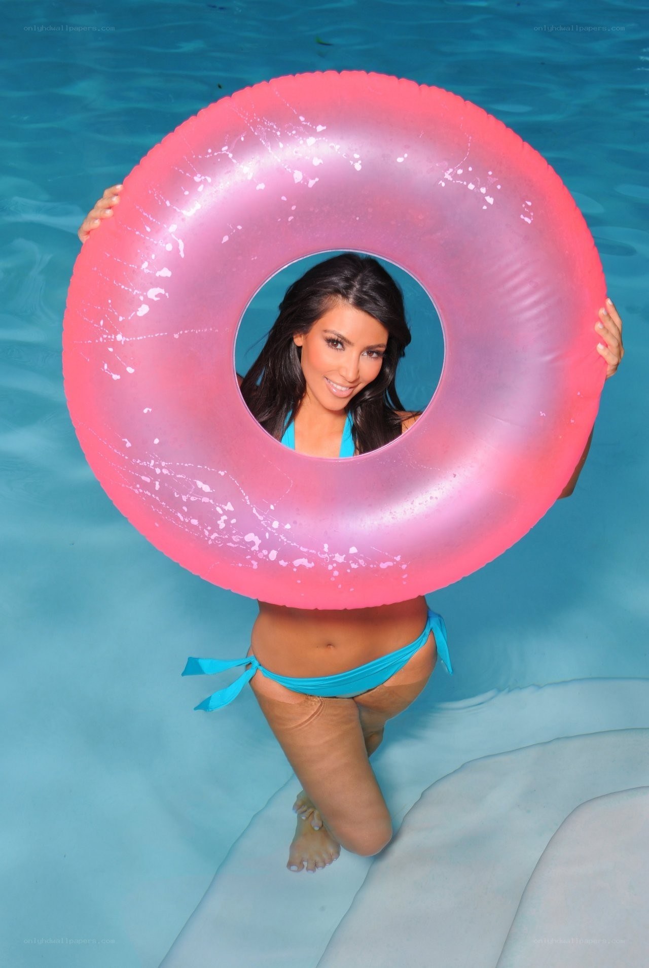 woman with pink float in pool