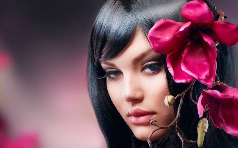 woman with pink flower in hair