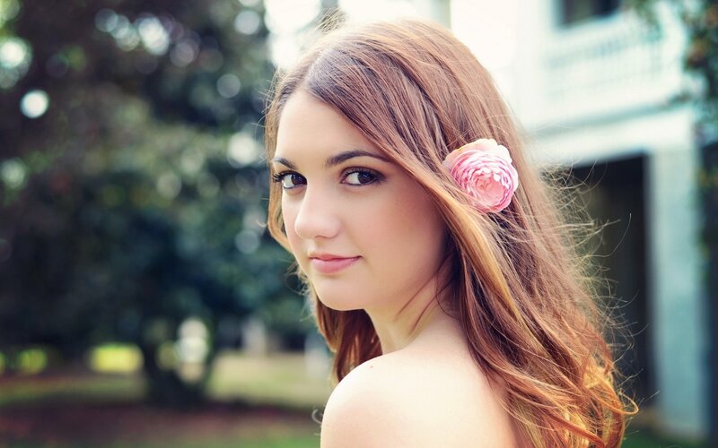 woman with pink flower in hair