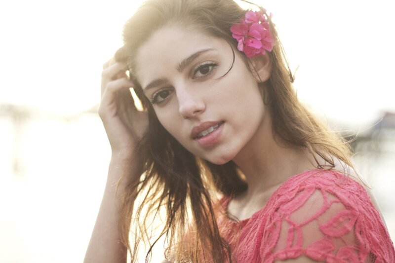 woman with pink flower in hair