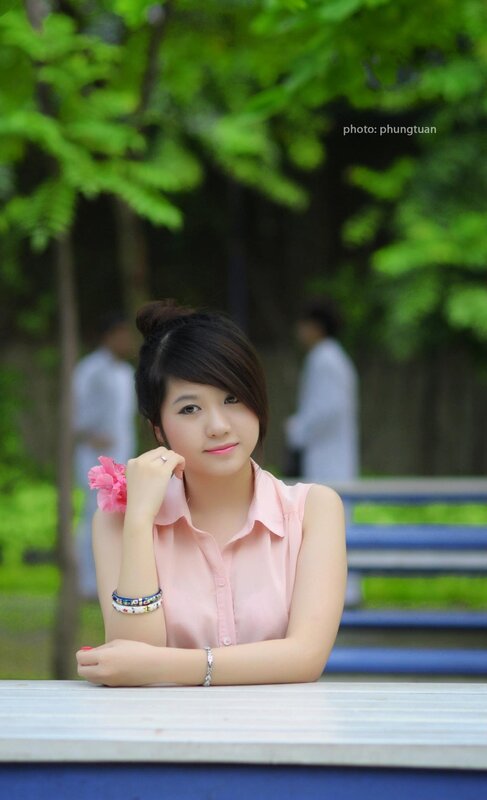 woman with pink flower in park