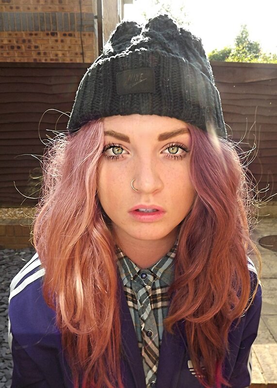 woman with pink hair and beanie