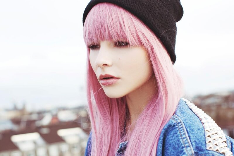 woman with pink hair and beanie