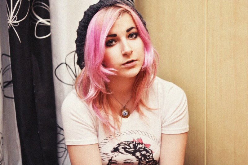 woman with pink hair and beanie