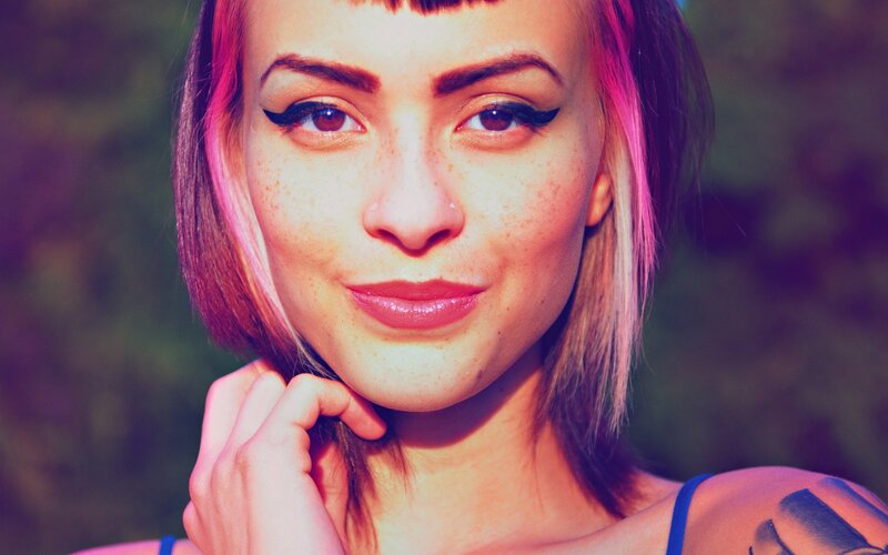 woman with pink hair and freckles