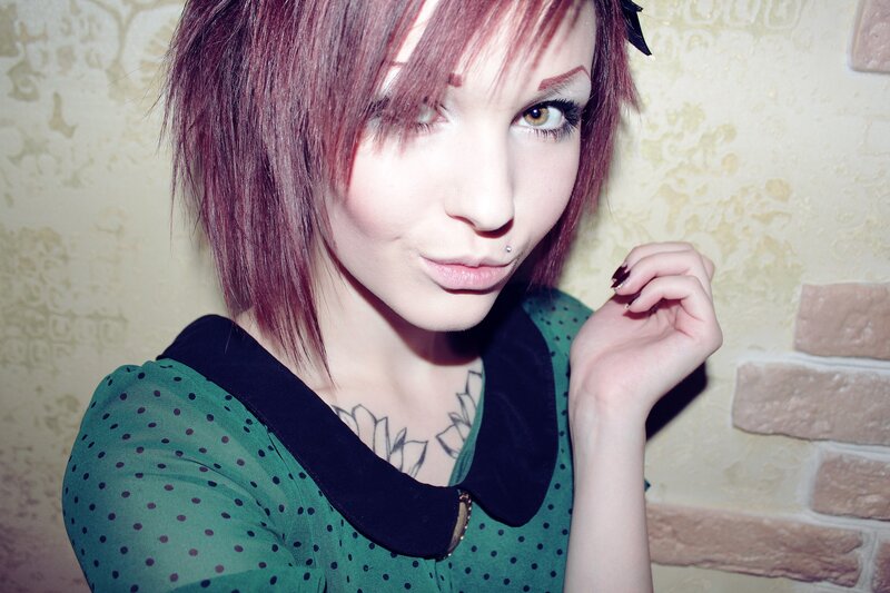 woman with pink hair and green dress