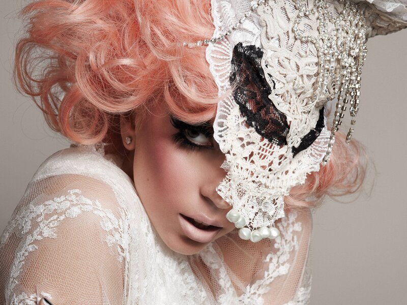 woman with pink hair and lace mask