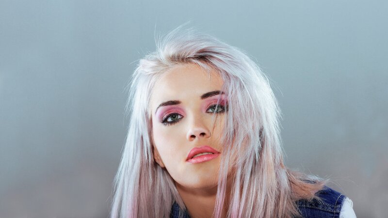 woman with pink hair and makeup
