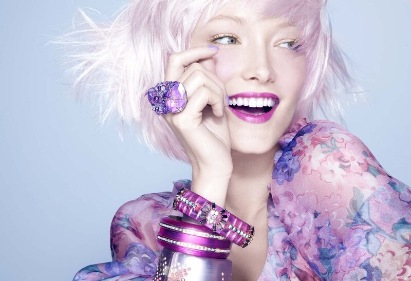 woman with pink hair and purple jewelry
