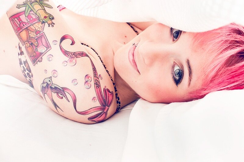 woman with pink hair and tattoos