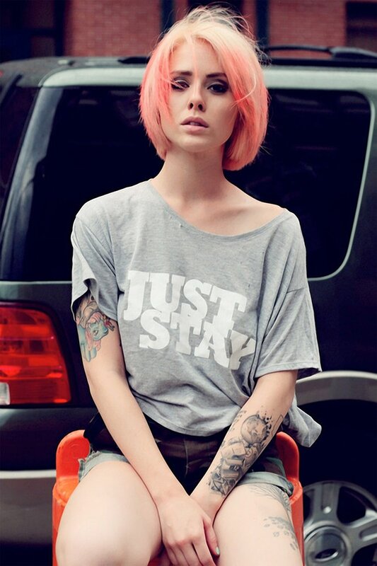 Woman with pink hair and tattoos