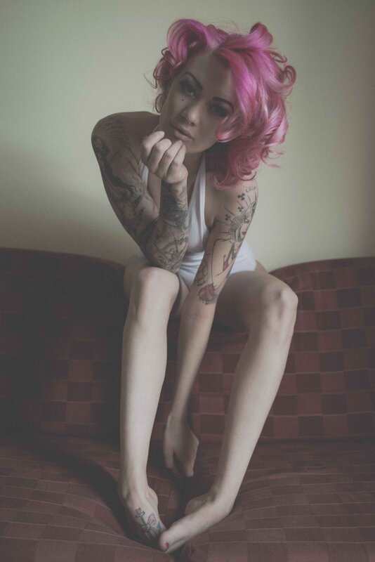 woman with pink hair and tattoos