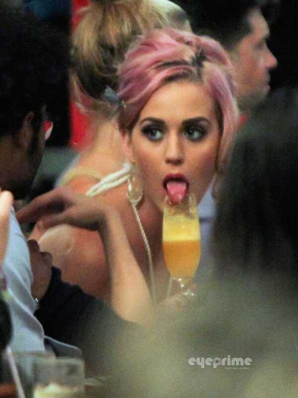woman with pink hair drinking