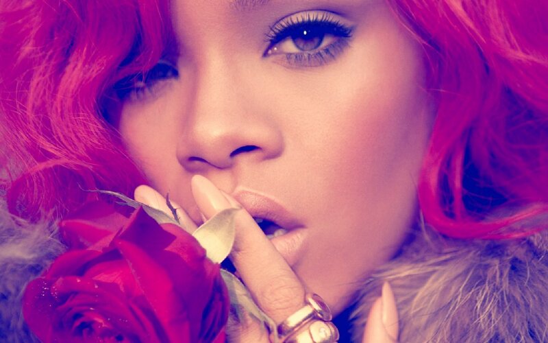 woman with pink hair holding rose