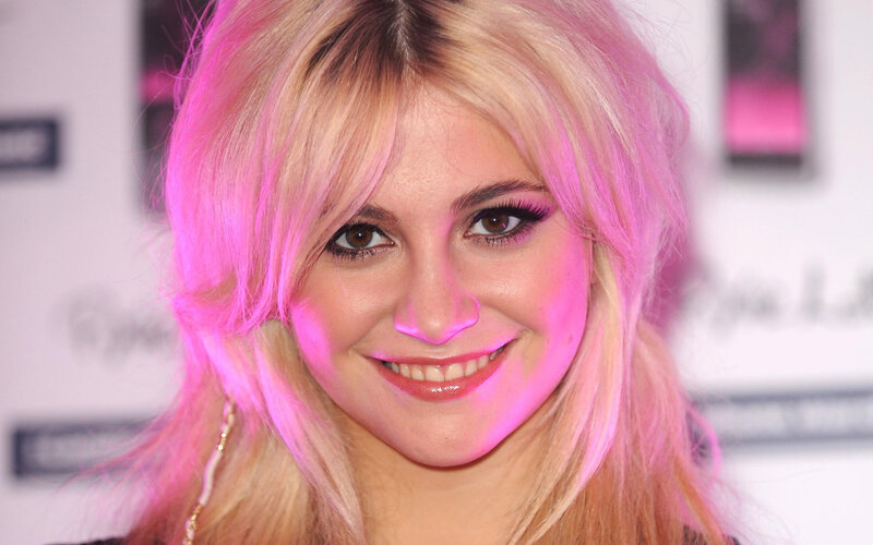 woman with pink hair smiling