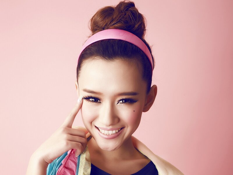 woman with pink headband smiling